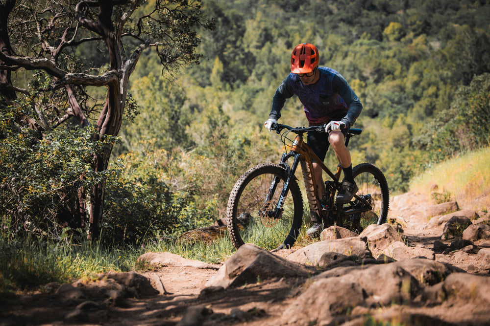 Man rides bike uphill and round corner