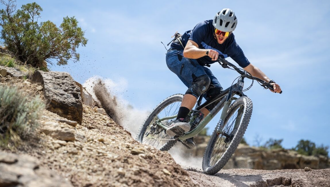 Male rider cycling down a rocky hill on a Marin bike