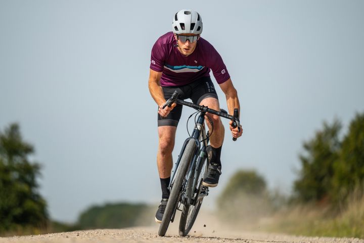 Man rides a gravel road on a dropbar bike