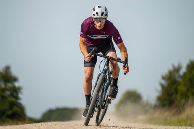 Man rides a gravel road on a dropbar bike