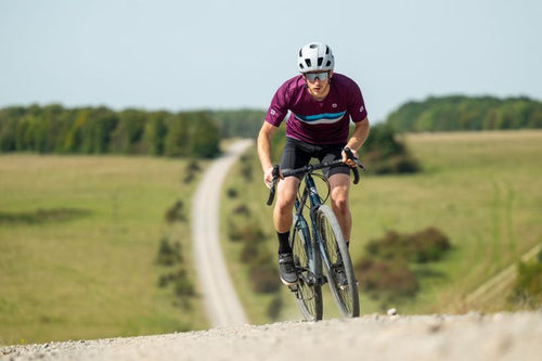 Man rides a gravel road on a dropbar bike