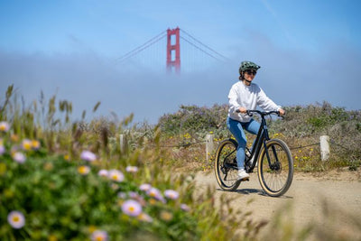 Woman rides a gravel track near the Golden Gate Bridge