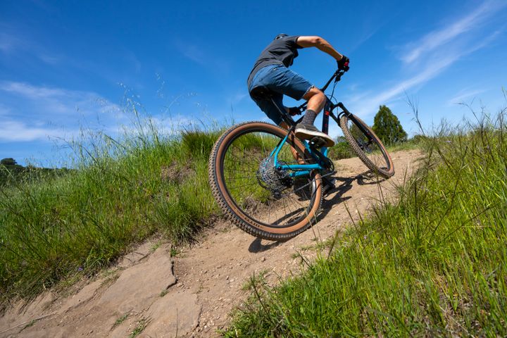 Man rides uphill on a mountain bike