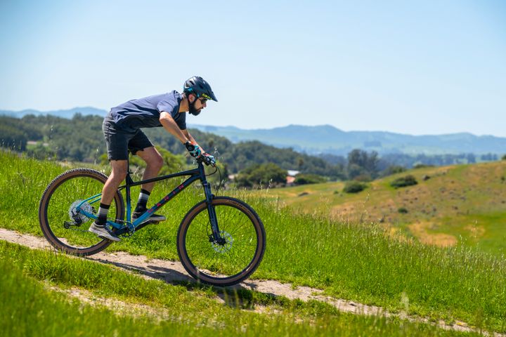 Man rides a mountain bike downhill
