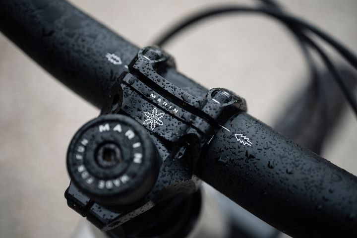 Close-up of a black bicycle handlebar with 'Marin' branding.
