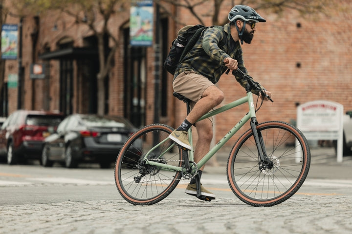 Man rides a bike in an urban location