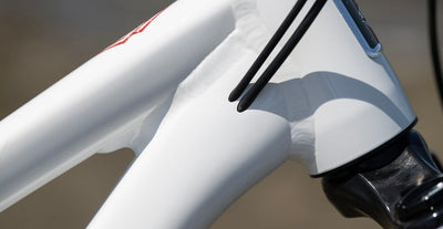 An image of a Marin Bikes mountain bike with internally routed brake, gear and dropper cables where they enter the frame by the head tube