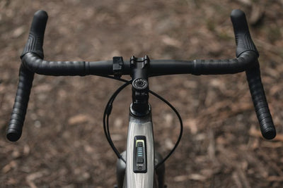 Close-up of a bicycle handlebar with blurred background