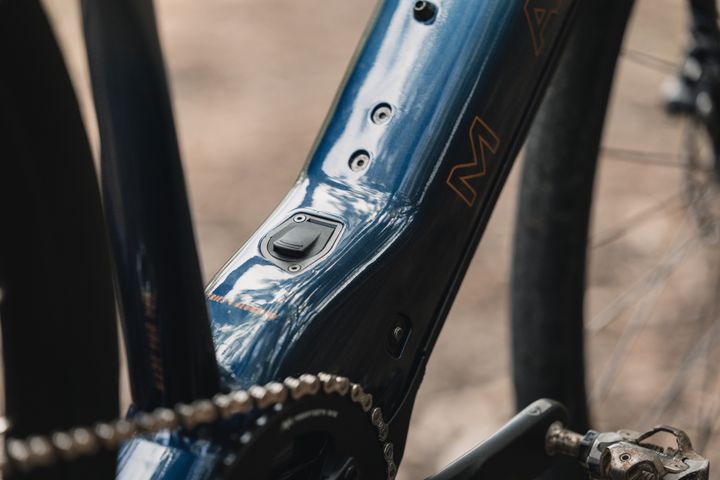 Close-up of a bicycle frame with chain and pedal, blurred background