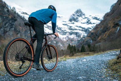 Man riding a gravel path in the mountains