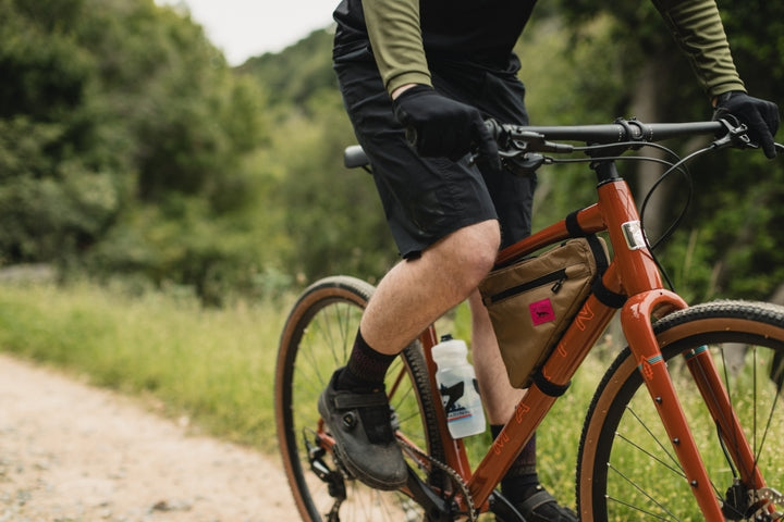 Man rides along a gravel track in woodland