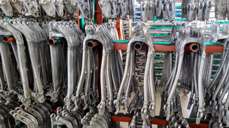 An image of a bicycle manufacuring facility with lots of bike frames stacked up on racking ready to be painted and assembled