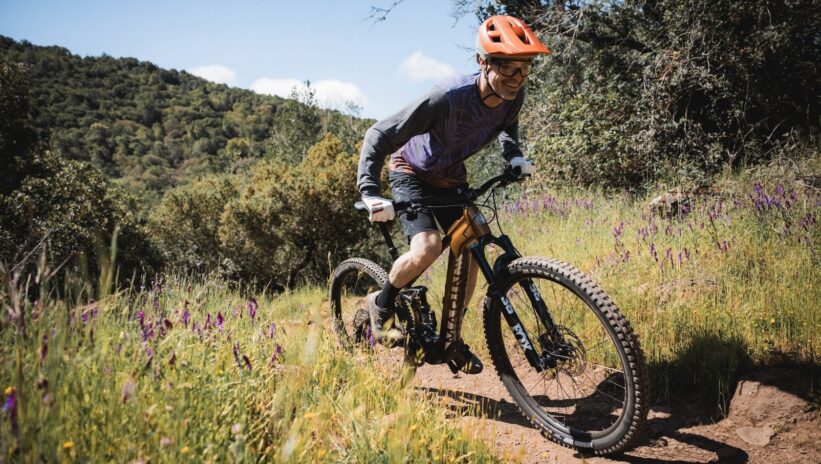 Man rides an ebike uphill off road
